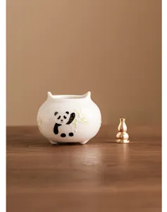Handmade ceramic panda incense burner with cute bamboo design and brass gourd holder.