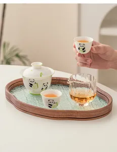 Exquisite Chinese ceramic panda kung fu tea set with gaiwan cups and glass tray details.