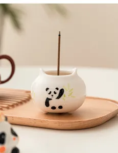 Close-up of a hand-painted ceramic panda incense holder, perfect for home tea accessories.