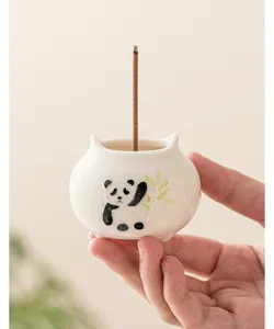Handcrafted ceramic panda incense burner holder detail shot for home interior tea decor.
