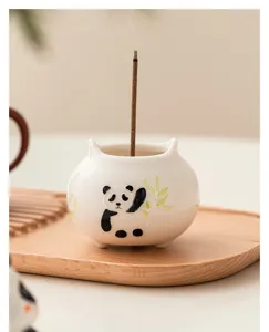 Hand-painted ceramic panda incense holder detail showing exquisite craftsmanship and texture.