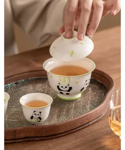 Hand-painted panda ceramic gaiwan tea set detail showing exquisite relief carving.