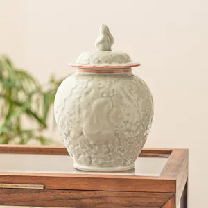 Boîte à thé en céramique avec couvercle lapin en relief, pot de stockage floral élégant.