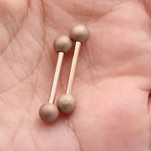 Detailed view of frosted straight bar nipple ring with mud balls, size 1.6x16mm.