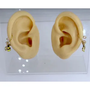 Detailed view of 316L stainless steel bee non-piercing body jewelry piece on display.