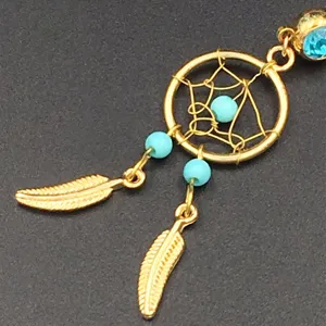 Gold dreamcatcher navel ring with blue beads and feather charms fashion body piercing.