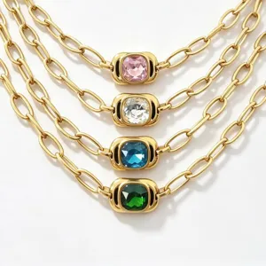 Close-up detail of multi-layer gold chain necklaces featuring vibrant colorful crystal pendants.