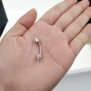 Stainless steel curved barbell detail shot, body piercing jewelry close up view showing cone ends.