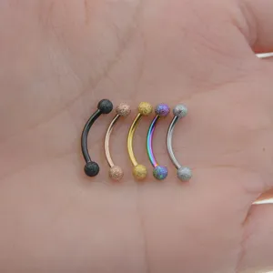 Stainless steel curved barbell eyebrow ring set featuring textured sand balls in various colors.