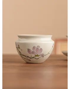 Hand-painted magnolia ceramic tea wash detail, elegant Chinese tea ware accessory close-up view