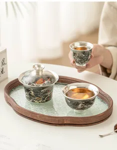 Detail view of 999 silver-plated kung fu tea set gaiwan and teacup on elegant tray.