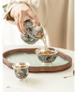 Exquisite 999 gilded silver gaiwan tea set with glass tea tray, elegant kung fu tea cups.