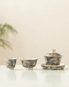 Detailed view of exquisite 999 silver-plated Chinese kung fu tea set with dragon and wave design.