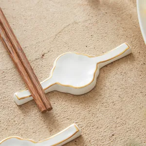 Bone china gold-rimmed chopstick rest for elegant hotel and restaurant table settings.