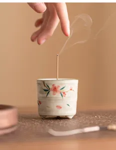Bruciatore di incenso in ceramica dipinto a mano con motivo di fiori di pesco, dettaglio elegante.