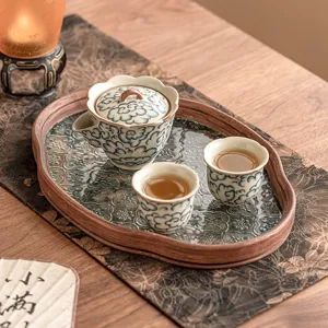 Celadon tea set with teapot and two cups, vintage cloud pattern design for home use.