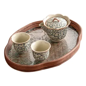Elegant ceramic tea set with cloud pattern, including one teapot and two cups on tray.