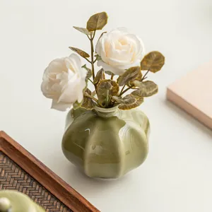 Green ceramic vase with artificial white roses flowers home decor tabletop ornament display
