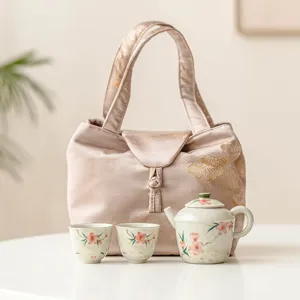 Set de té kung fu de cerámica portátil con tetera, dos tazas y bolsa de tela para viajes.