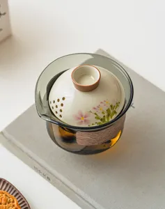 Détail de service à thé tasse rapide céramique marguerite peinte, couvercle filtre Dehua.