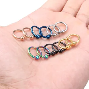 Detailed view of colorful captive bead rings, titanium body piercing jewelry pieces.