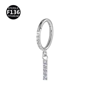 Detailed close-up view of F136 titanium clicker hoop piercing with sparkling cubic zirconia charm.