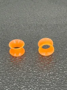Soft silicone double flare ear tunnels for body piercing jewelry detailed view, vibrant orange.