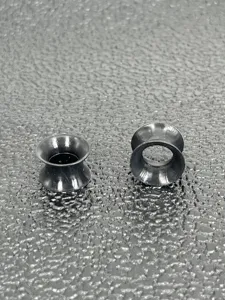Detailed view of black double flare ear tunnel plug, professional body piercing detail.