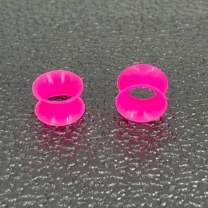 Soft silicone double flare ear tunnels for body piercing jewelry, vibrant pink style.