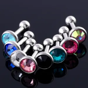 Close-up of colorful crystal stainless steel cartilage ear studs, body piercing jewelry.