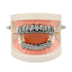 Detail view of silver tone metal grillz teeth set for hip hop fashion and party wear style.