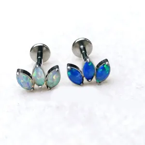 Titanium body piercing jewelry detail showing three marquise opal cluster design studs clearly.