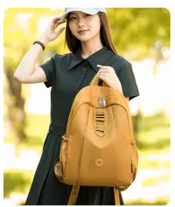 Detail view of the stylish yellow nylon backpack with front zippered pocket and D-ring.
