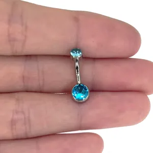 Detail shot of G23 titanium belly button ring featuring sparkling blue zircon on bar.