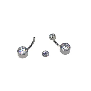 Titanium belly button ring detail view showing curved barbell and sparkling crystal stones.