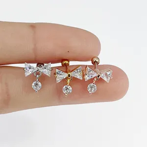 Stainless steel bow zircon piercing detail, elegant cartilage earring jewelry piece.