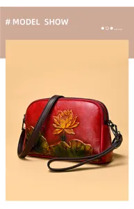 Detailed view of retro embossed lotus red leather crossbody bag with vintage style texture.