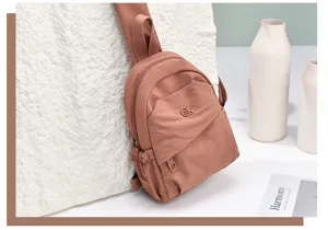 Detailed view of the stylish casual nylon mini backpack in solid color with front pocket.
