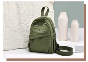 Dark green nylon mini backpack for women, casual daily bookbag, lightweight travel rucksack.