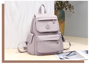 Light purple casual backpack for women, large capacity nylon school bag, stylish travel daypack.