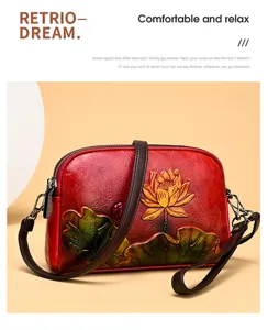 Detail view of vintage embossed lotus women leather shoulder bag with ethnic chic style.