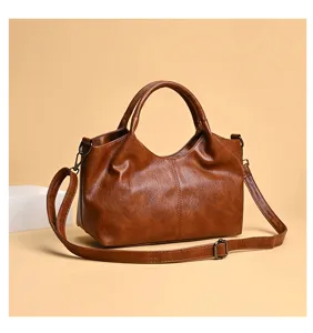Detail view of the brown soft PU leather women shoulder crossbody tote bag with handle.