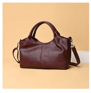 Detailed view of the burgundy soft PU leather handbag showing texture and strap attachment.