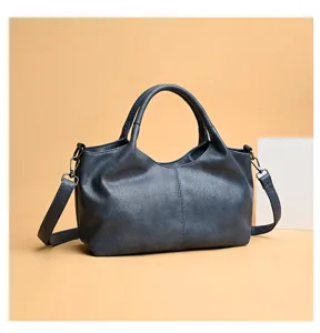 Detailed view of the dark blue soft PU leather tote bag with shoulder strap and metal hardware.