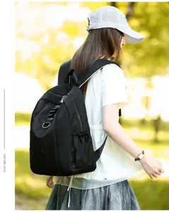 Detail view of casual black nylon backpack on model, lightweight and stylish for daily outdoor use.