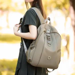 Casual nylon backpack for women, stylish khaki travel daypack with shoulder straps.