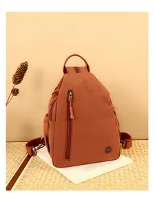 Detailed view of the multi-layer nylon chest bag in caramel brown, casual crossbody design.