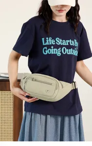 Detail view of the casual waist bag highlighting multiple functional zippered storage pockets.
