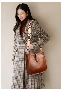 Brown leather hobo bag with patterned strap, vintage bucket shoulder bag for women.