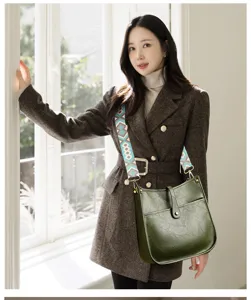 Detailed view of the dark green leather hobo shoulder bag with a stylish geometric wide strap.